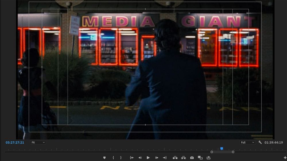 A man stands in front of a video store called Media Giant.