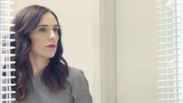Jacinta Ardern looks out of an office.